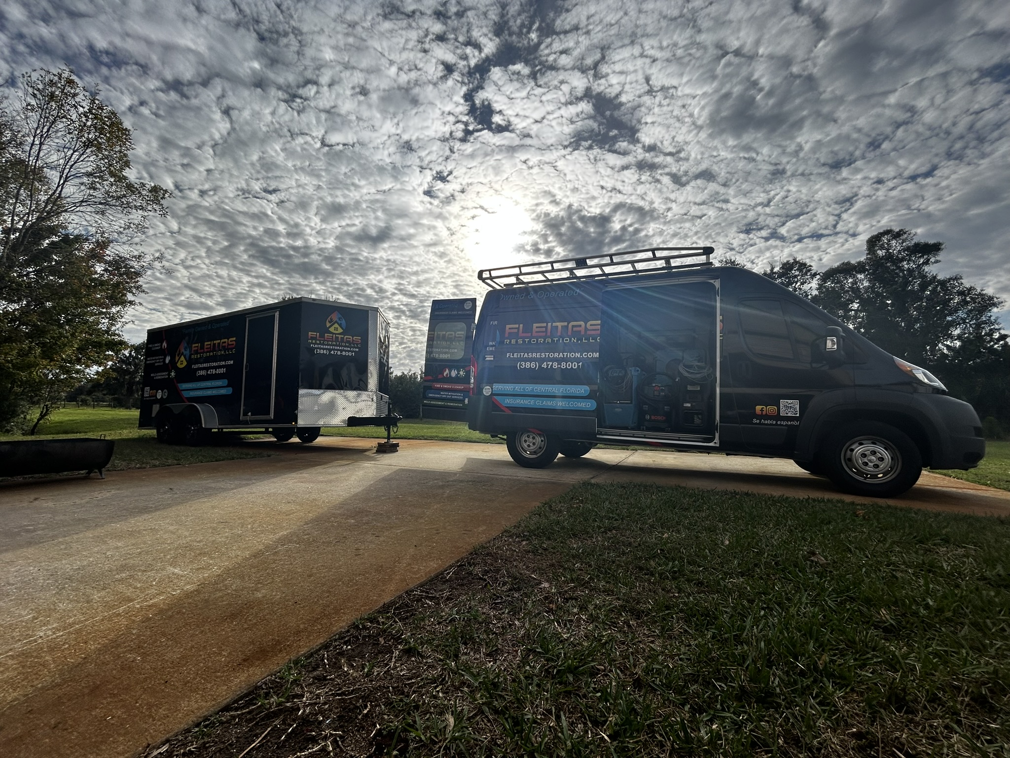 Fleitas Restoration van and trailer on sunny day.