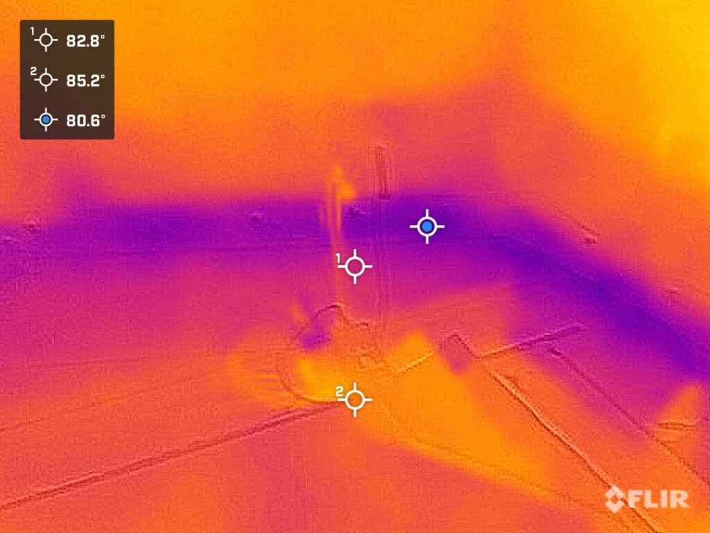 Thermal image with temperature readings and anomaly.