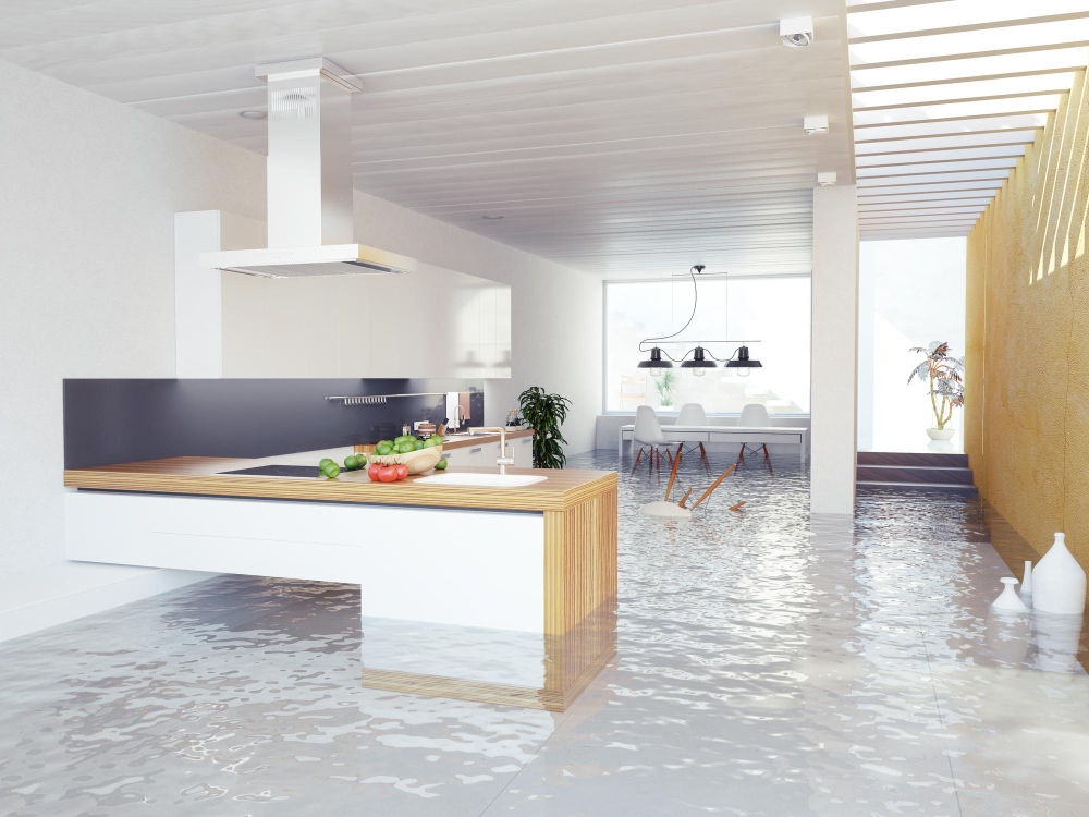 Modern kitchen and dining area flooded with water.